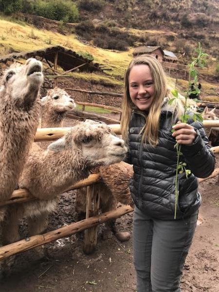 Hannah Moore posing with llamas